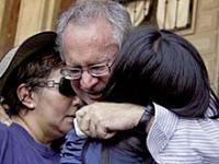 Javier Sicilia hugs two women